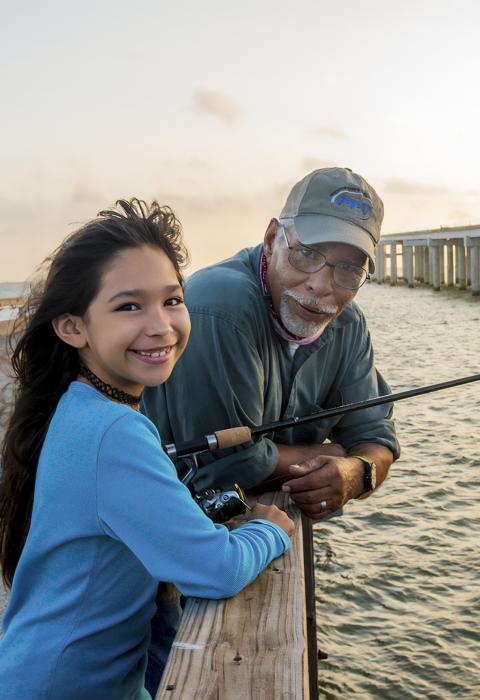 Grandfather and granddaughter enjoy a day of fishing at the Copano Fishing Pier located on Rock Port Texas. 