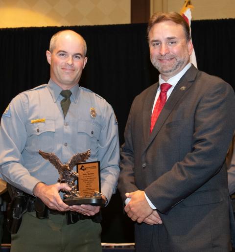 The winner of the law enforcement award poses with the SEAFWA president